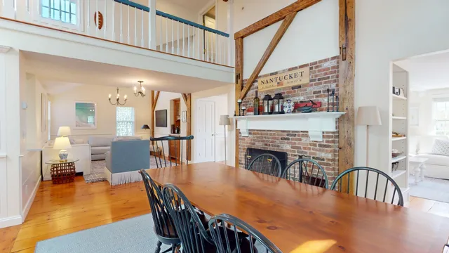 a dining room with furniture a rug and wooden floor