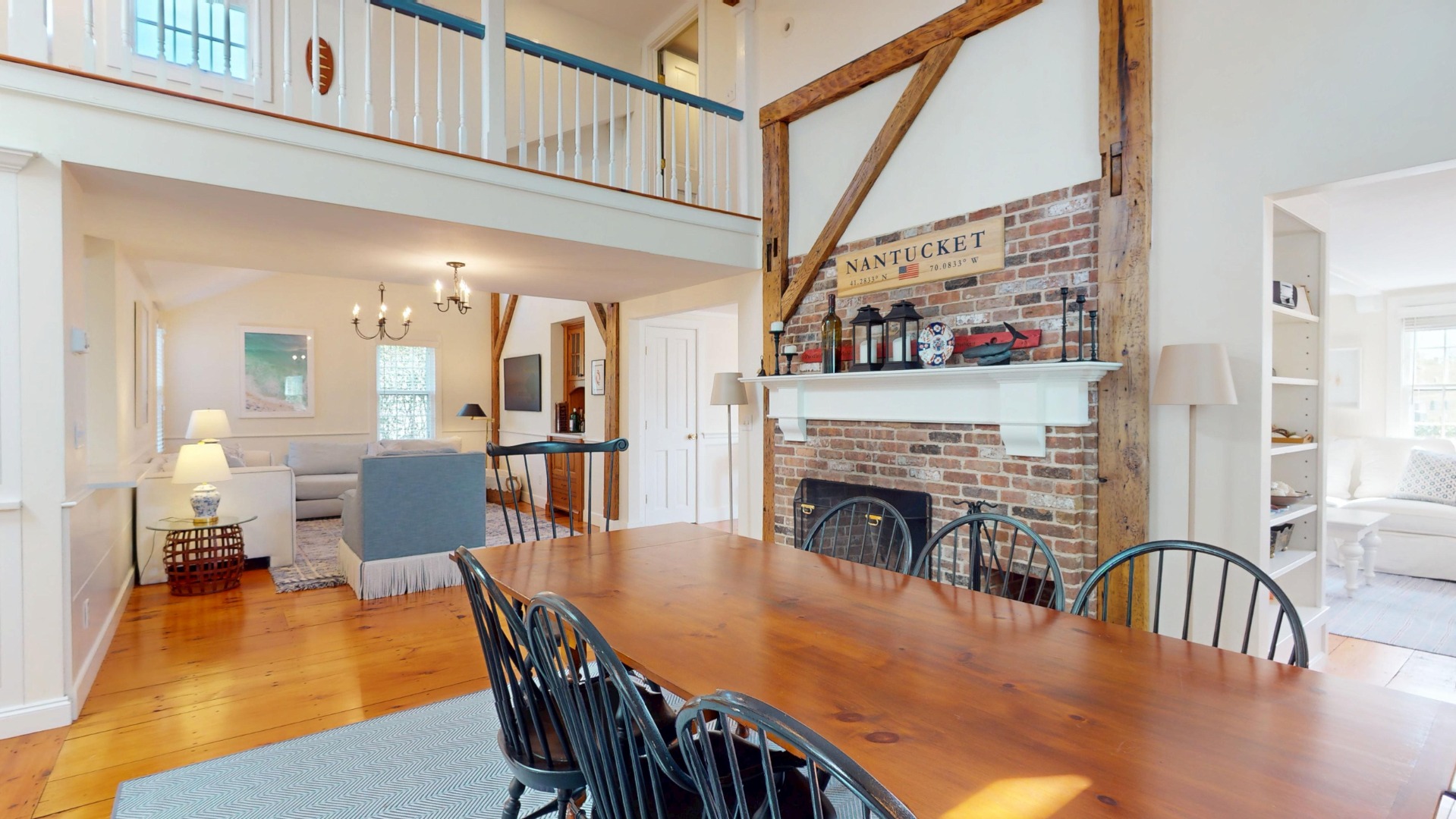 39 A Milk Street Nantucket, MA 02554 - Photo 8 of 56 a view of a dining room with furniture wooden floor and a fireplace