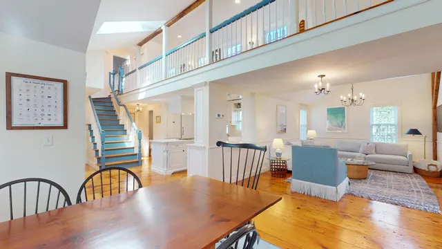 a living room with furniture a flat screen tv and a window
