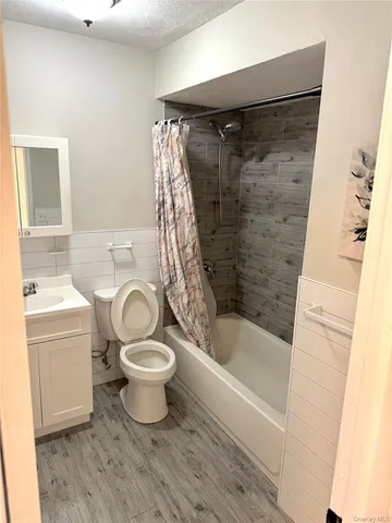 a bathroom with a sink toilet and mirror