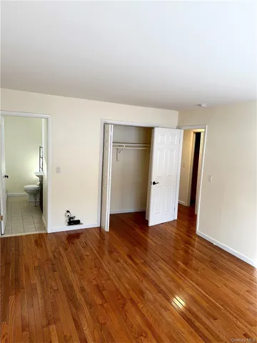 a view of hallway with wooden floor