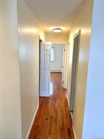 a view of a room with wooden floor and white walls
