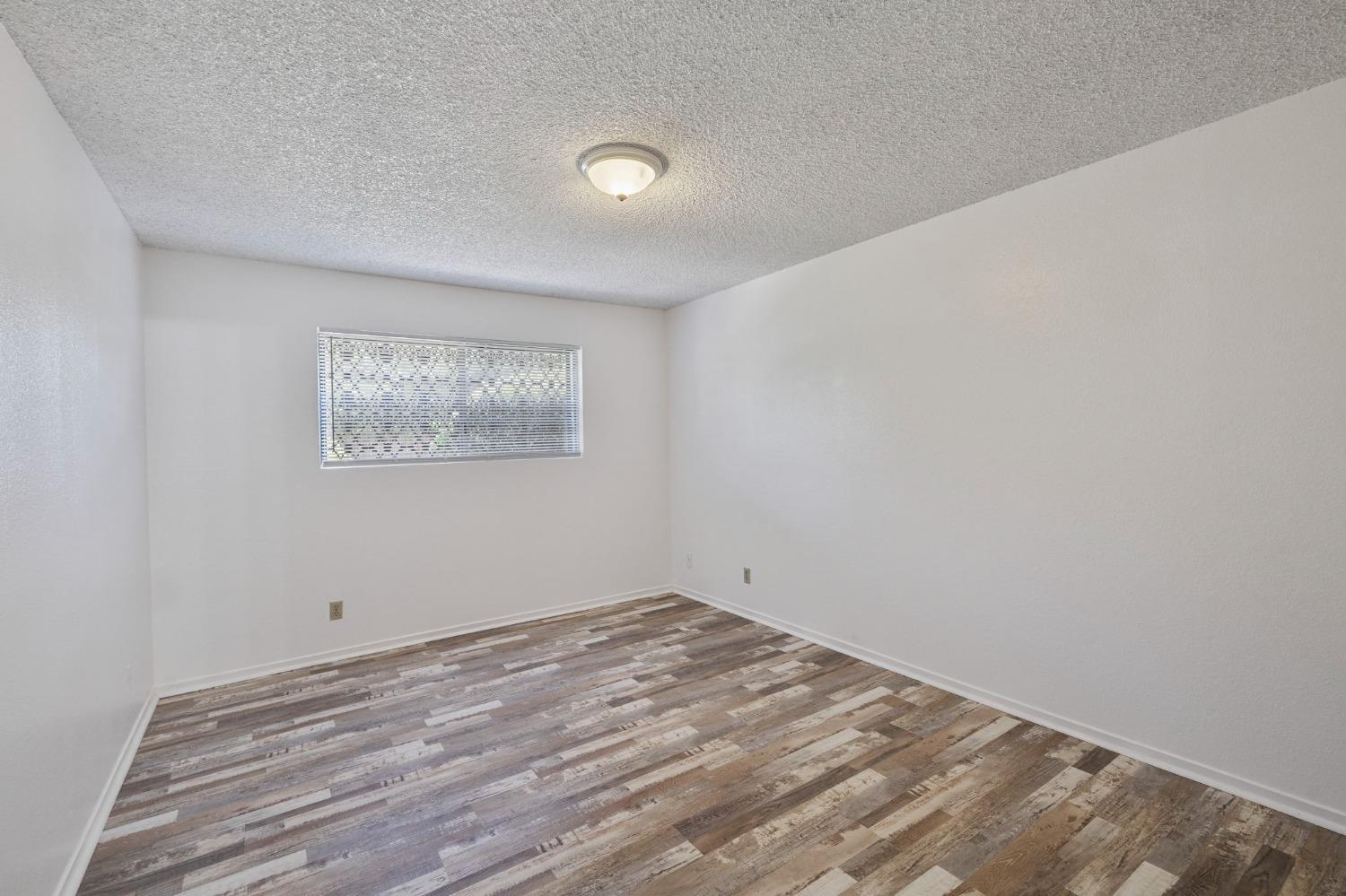 1520 South Reed Avenue Reedley, CA 93654 - Photo 11 of 20 a view of empty room with wooden floor