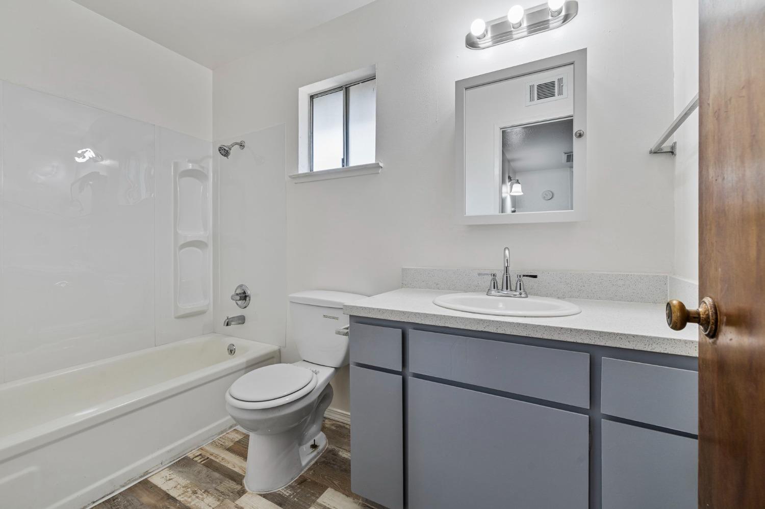 1520 South Reed Avenue Reedley, CA 93654 - Photo 13 of 20 a bathroom with a toilet sink and mirror