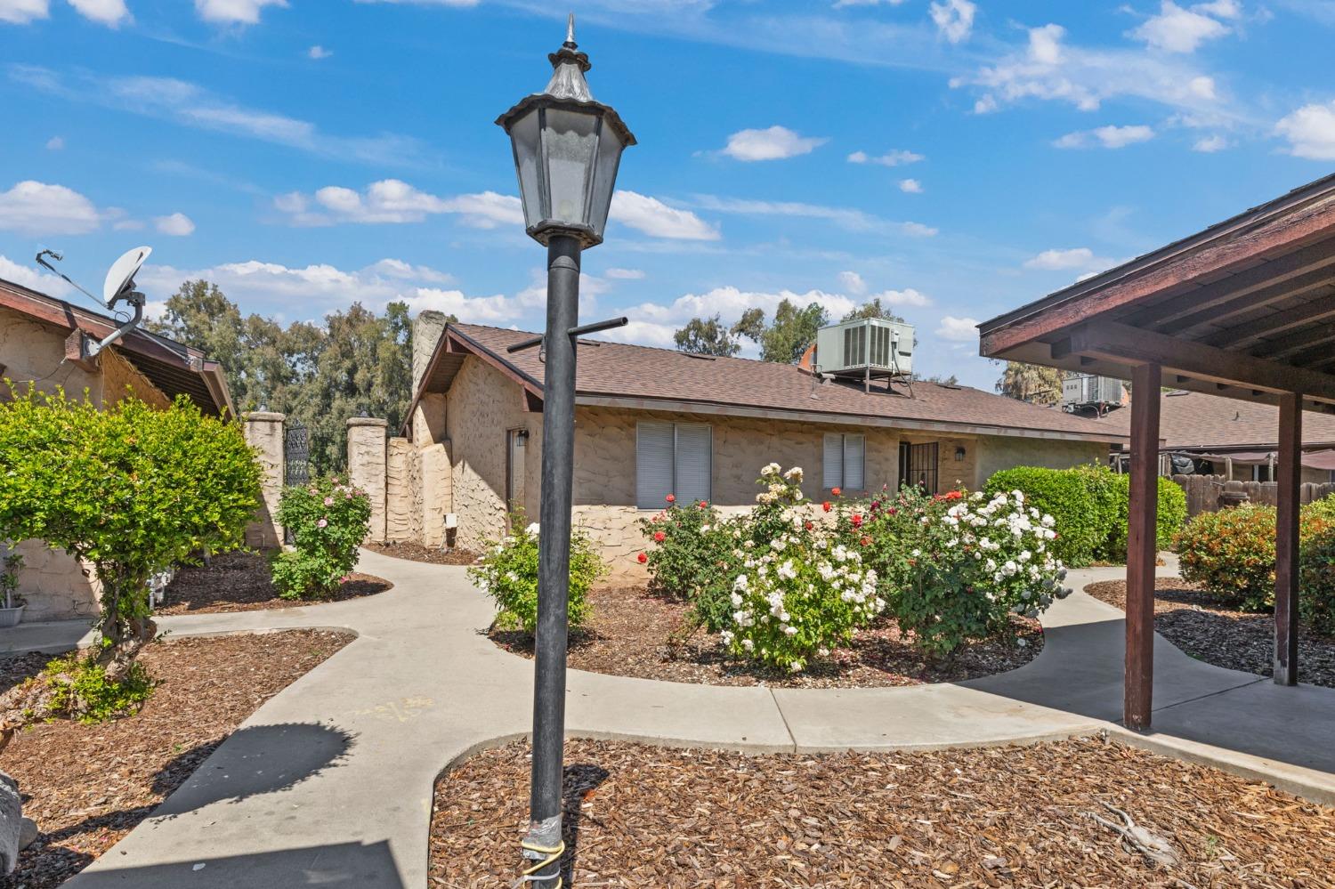 1520 South Reed Avenue Reedley, CA 93654 - Photo 14 of 20 a front view of a house with garden