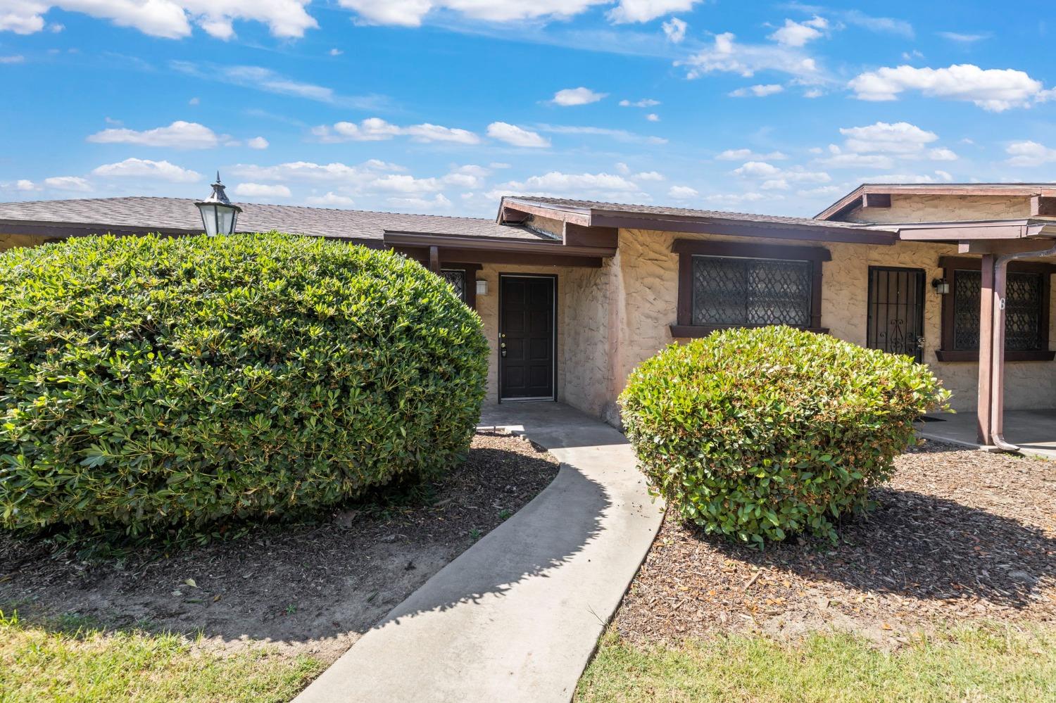 1520 South Reed Avenue Reedley, CA 93654 - Photo 6 of 20 a front view of a house with garden