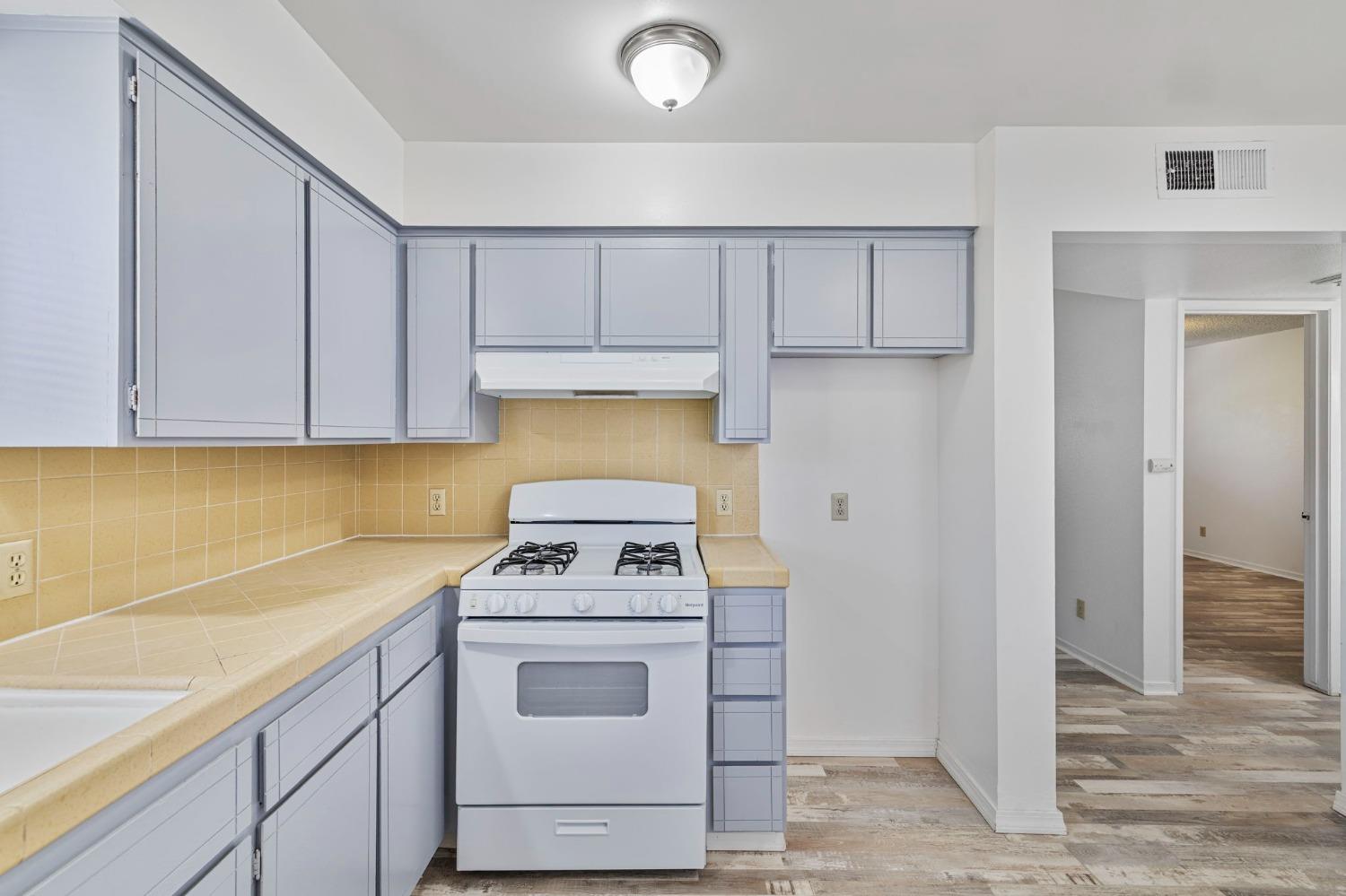 1520 South Reed Avenue Reedley, CA 93654 - Photo 10 of 20 a kitchen with a stove and a cabinets
