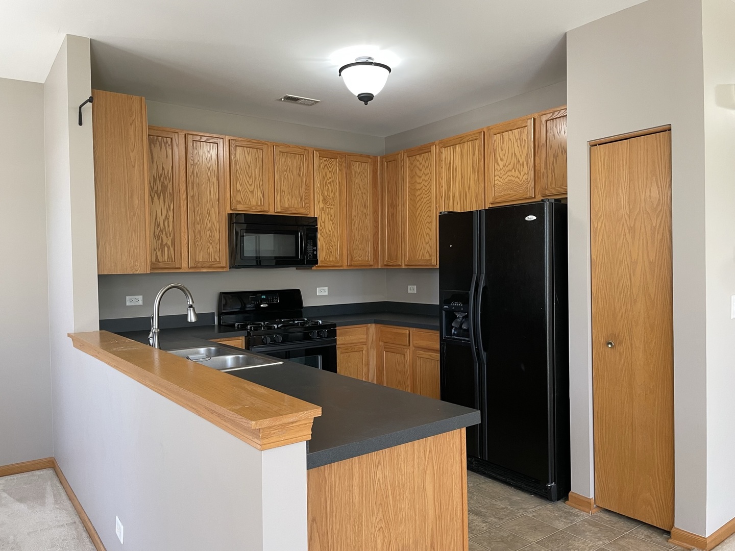 1531 Millbrook Drive Algonquin, IL 60102 - Photo 2 of 14 a kitchen with granite countertop wooden cabinets a refrigerator and a sink