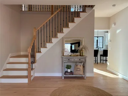 a view of entryway and hall with wooden floor