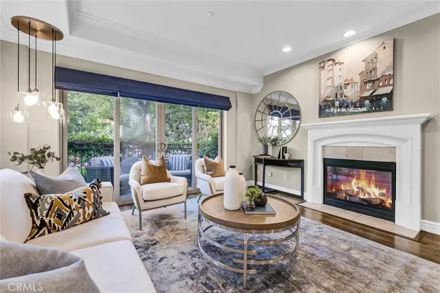 a living room with furniture a fireplace and a large window