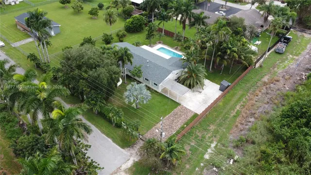 an aerial view of a house with a yard