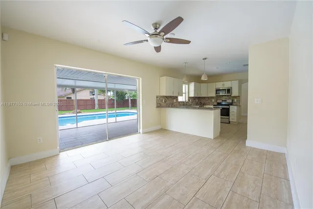 a view of a kitchen with a sink and a stove top oven
