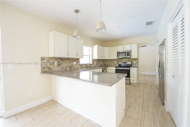 a large kitchen with cabinets
