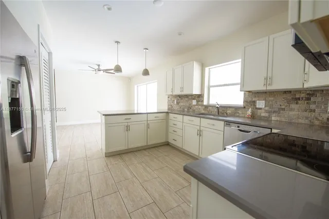 a kitchen with a sink appliances and cabinets