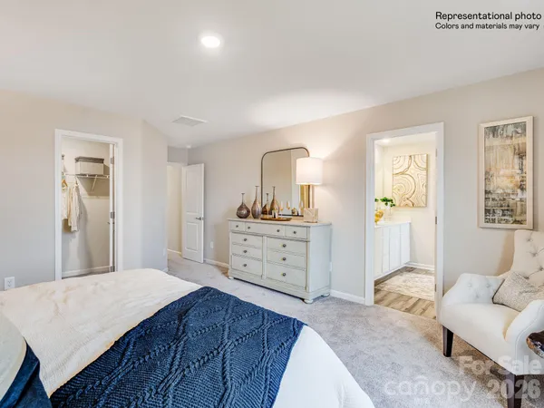 a spacious bedroom with a bed and a couch