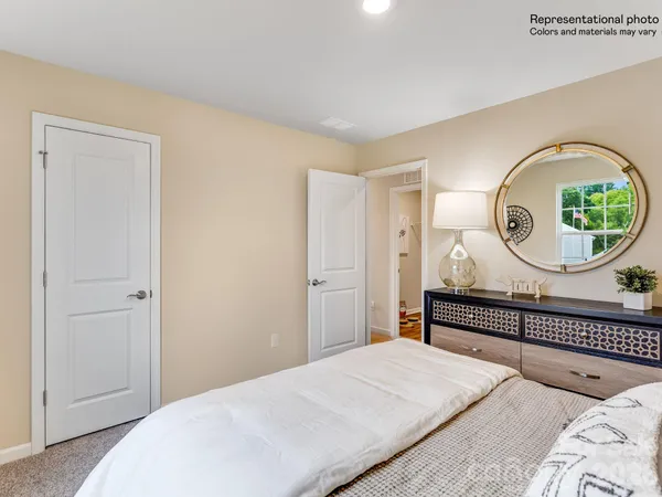 a bedroom with bed and a wooden floor