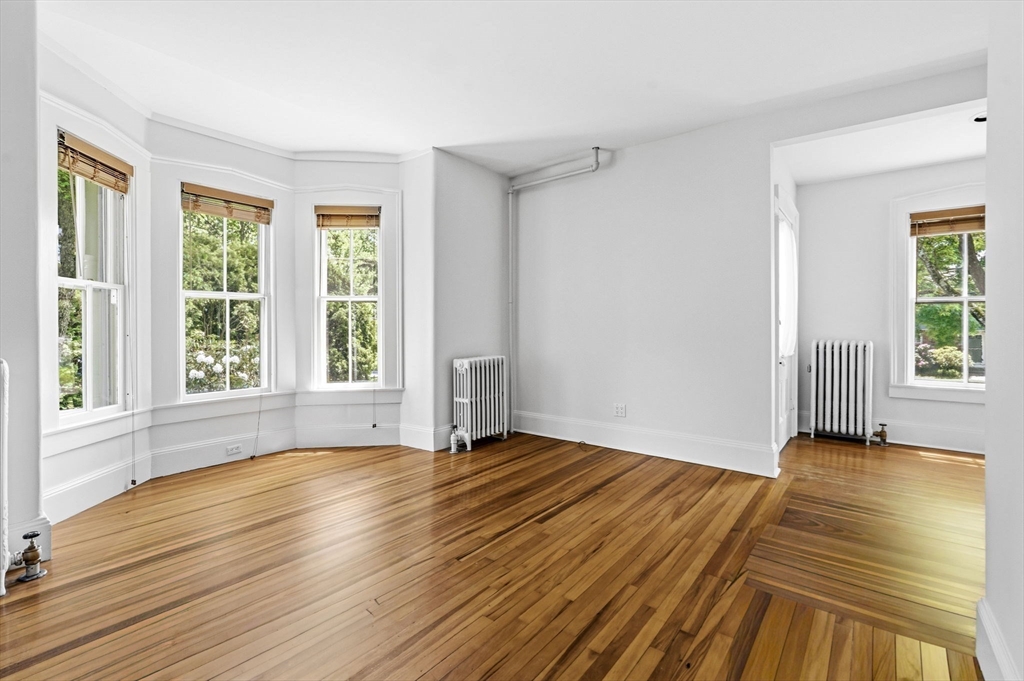58 Front Street Northampton, MA 01053 - Photo 28 of 42 a view of an empty room with wooden floor and a window