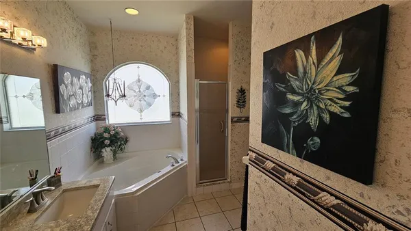 a room with painting and a potted plant