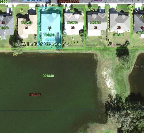 an aerial view of residential houses with outdoor space and lake view