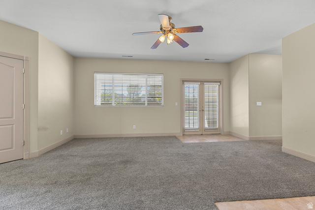 389 North Main Street St. George, UT 84770 - Photo 32 of 44 Unfurnished room featuring light carpet, ceiling fan, and french doors