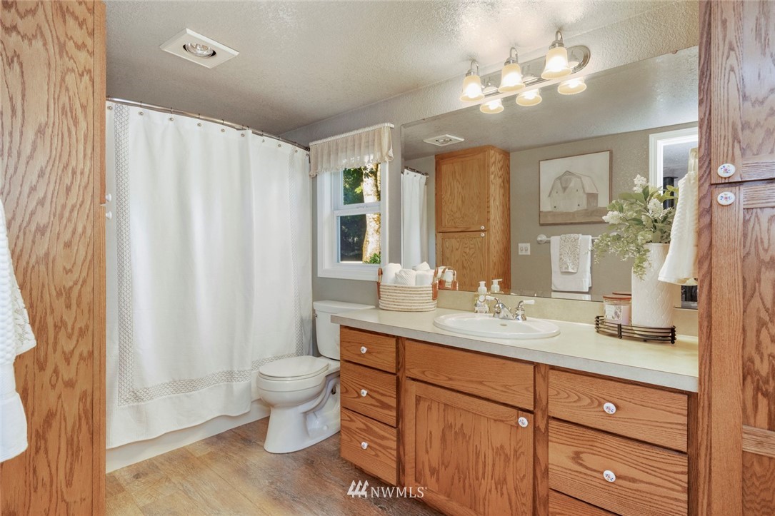 1125 Dyer Road Sultan, WA 98294 - Photo 8 of 22 a spacious bathroom with a double vanity sink toilet and a mirror