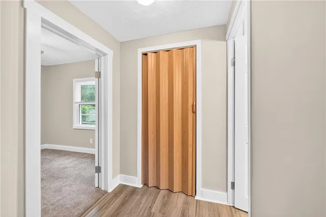 an empty room with wooden floor and a window