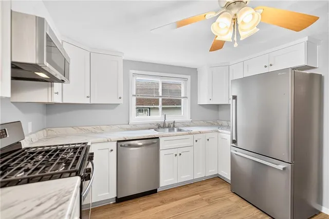 a kitchen with a white cabinets and white appliances