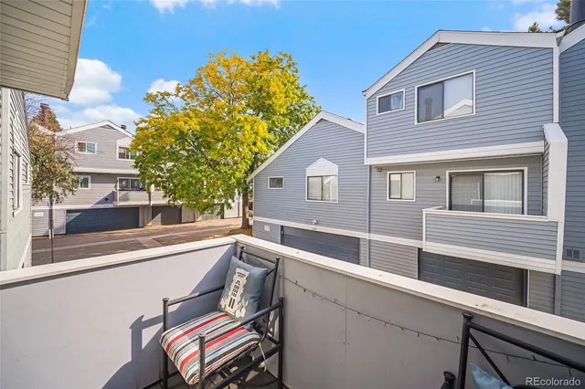 a view of a house with a backyard and a chair