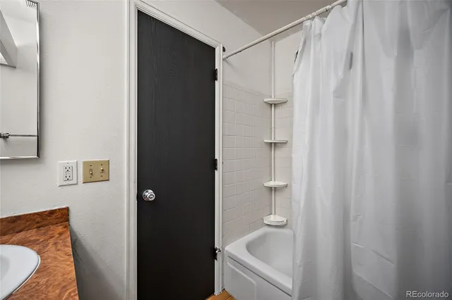 a bathroom with a tub and shower