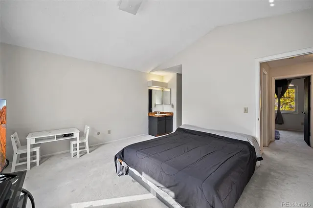 a bedroom with a bed and a chair