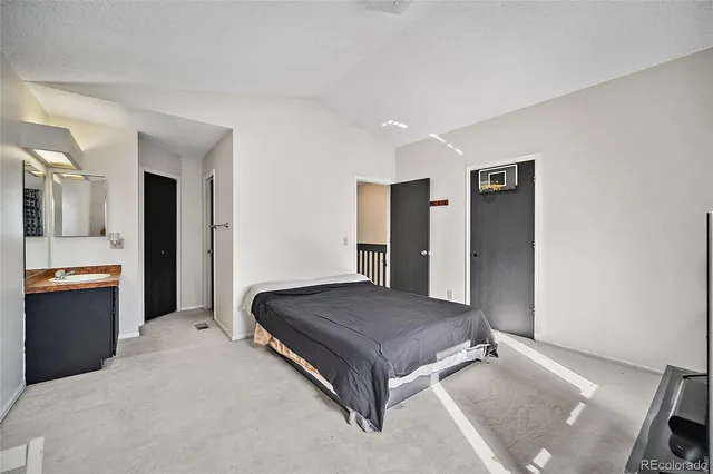 a spacious bedroom with a bed and window