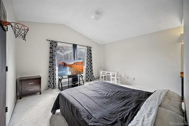 a bedroom with a bed and a tv on table