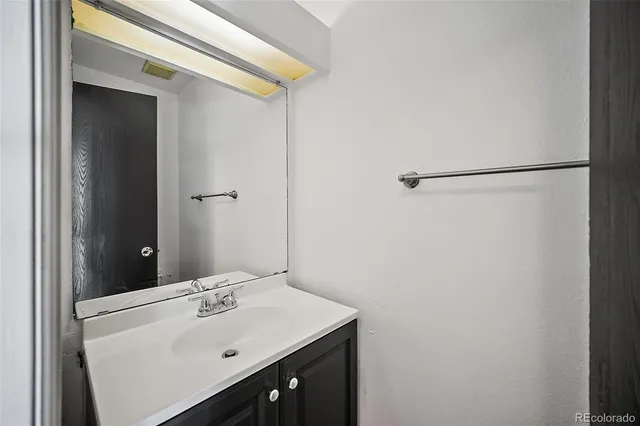 a bathroom with a sink and mirror