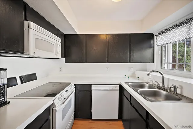 a kitchen with a sink cabinets and stainless steel appliances