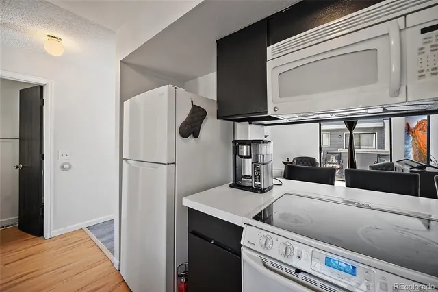 a kitchen with a refrigerator and a sink