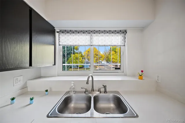 a kitchen with a sink and a large window