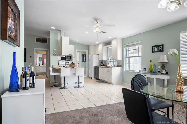 a living room with furniture and a kitchen