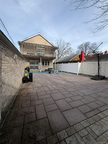 a man sitting on a bench in front of a building