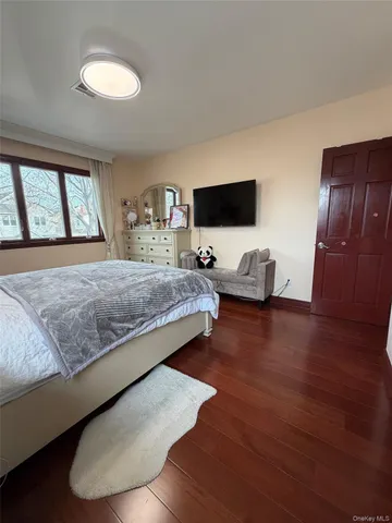 a bedroom with a bed and flat screen tv
