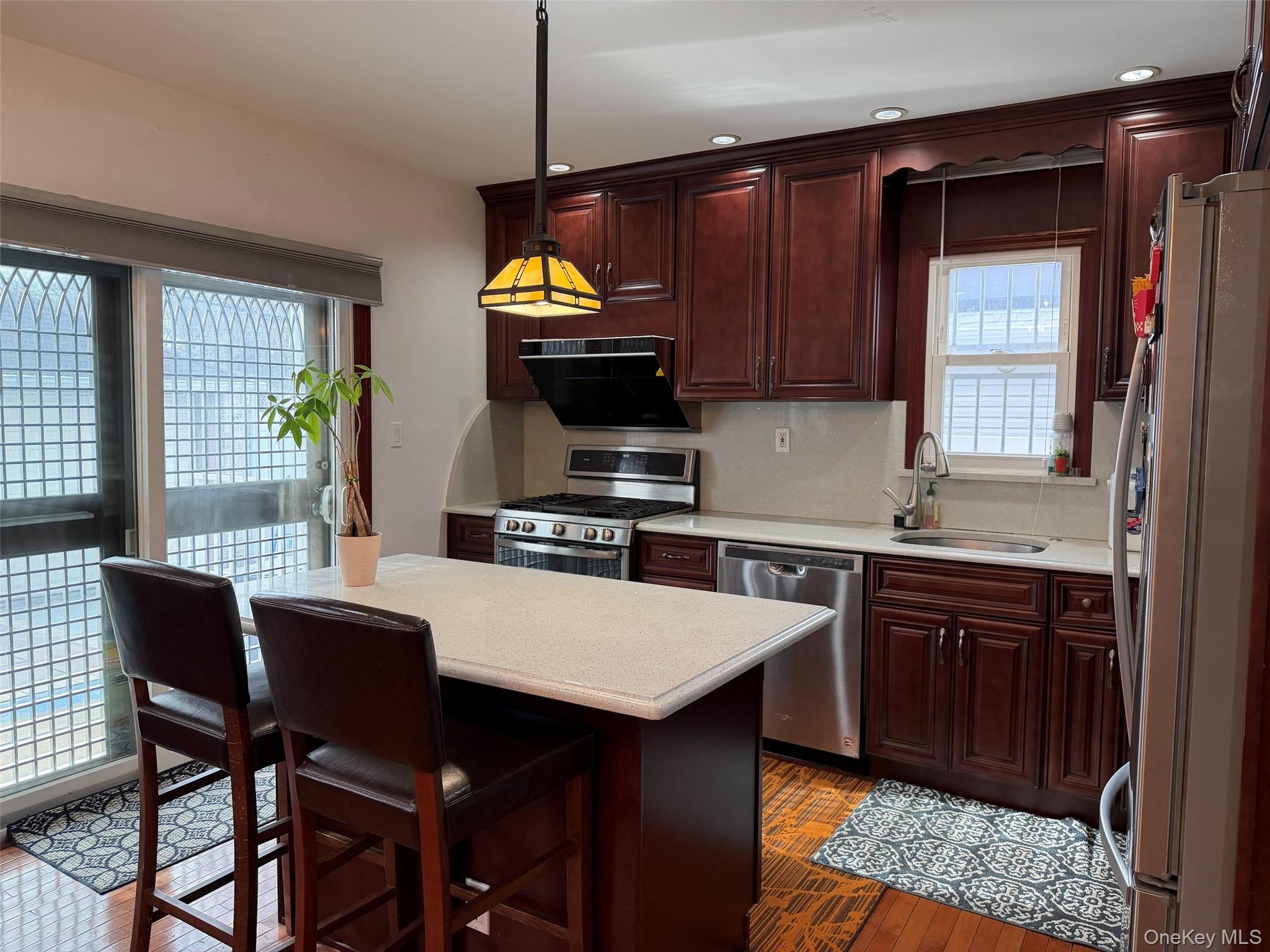 175-28 Underhill Avenue Queens, NY 11365 - Photo 5 of 24 a kitchen with a wooden table and chairs
