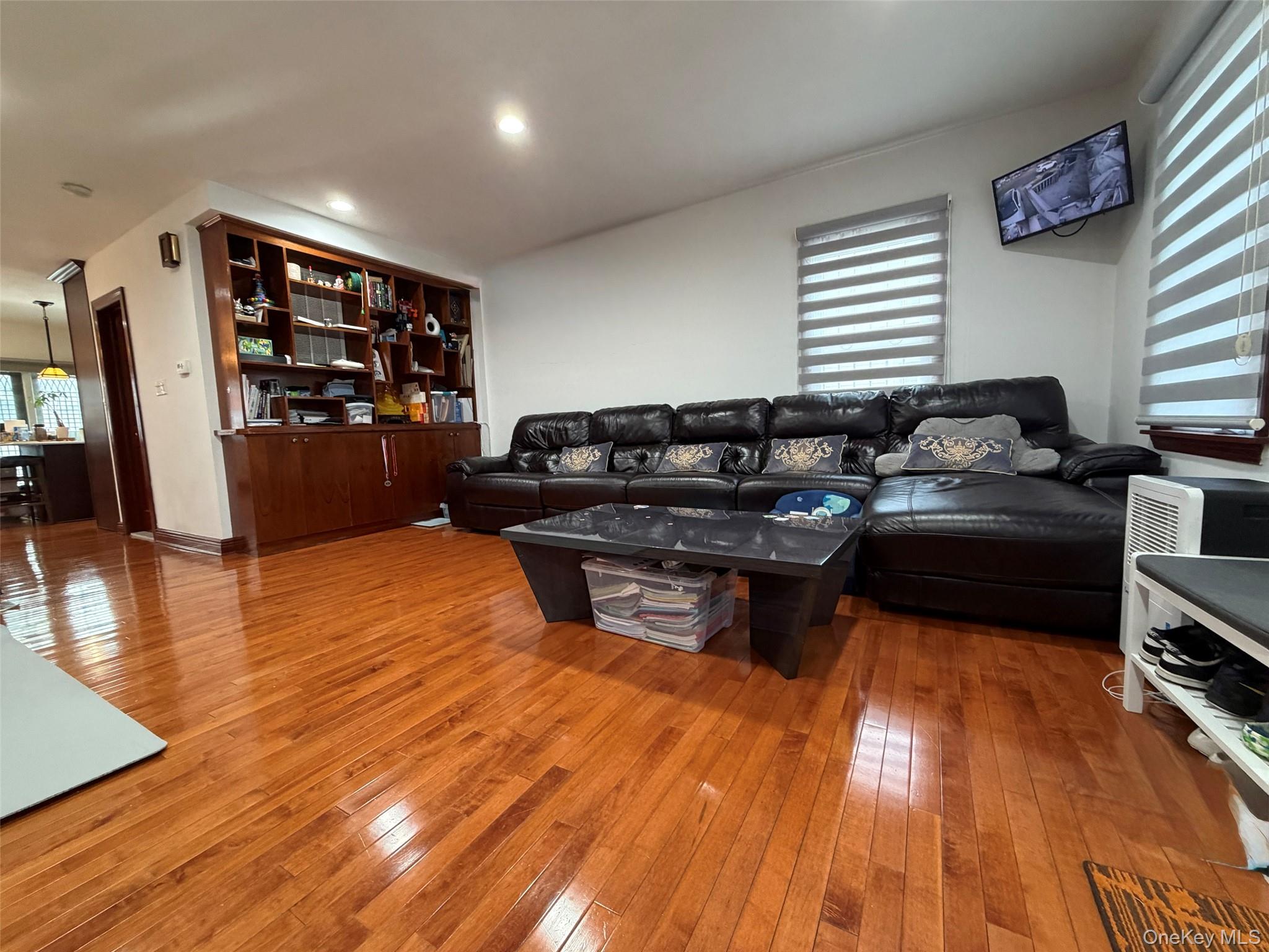 175-28 Underhill Avenue Queens, NY 11365 - Photo 7 of 24 a living room with furniture and a wooden floor