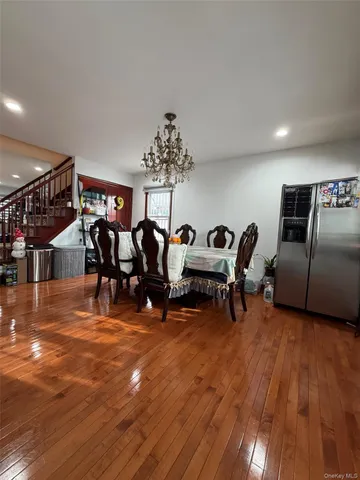 a living room with furniture and a hard wood floor