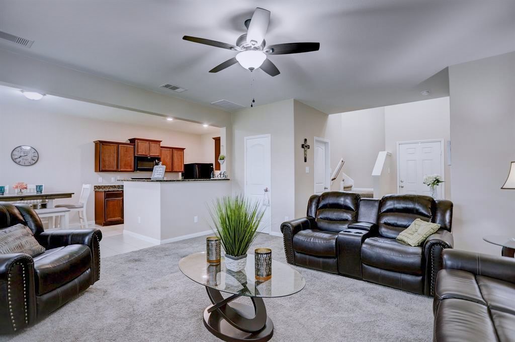 1303 Emerald Stone Drive Rosharon, TX 77583 - Photo 5 of 25 Stylish open-concept living room offering flexible space and effortless flow into the kitchen and dining areas.