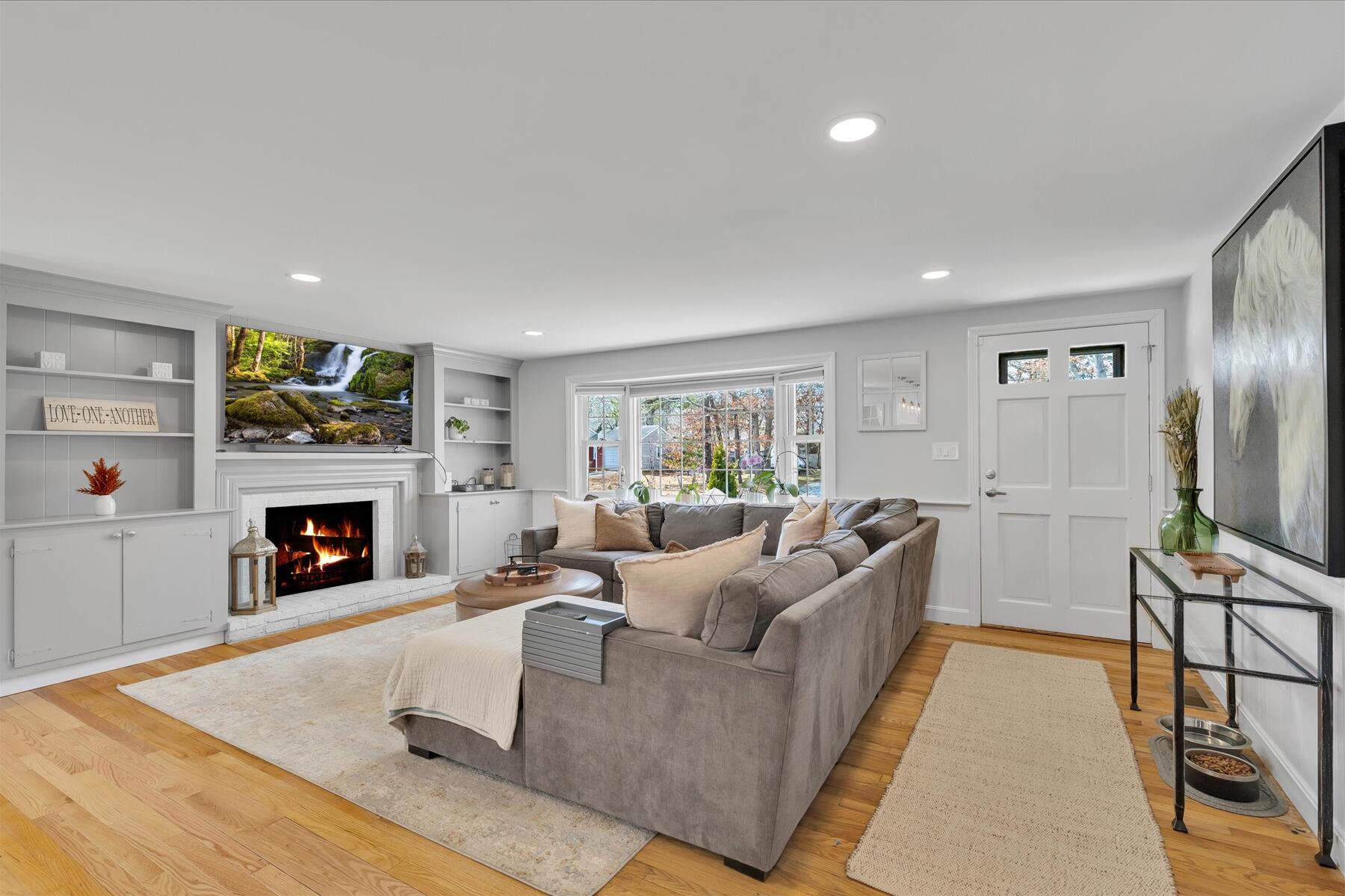 80 Coolidge Road West Yarmouth, MA 02673 - Photo 11 of 37 a living room with furniture and a fireplace