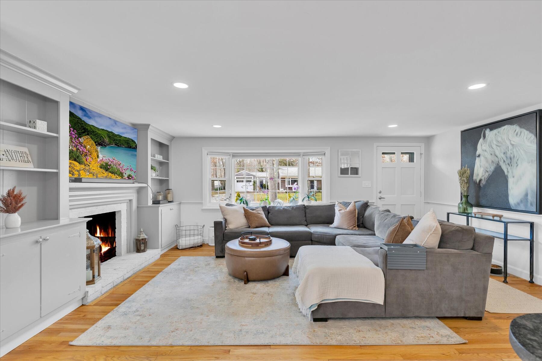 80 Coolidge Road West Yarmouth, MA 02673 - Photo 12 of 37 a living room with furniture and a fireplace