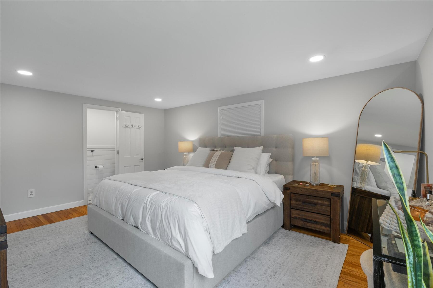 80 Coolidge Road West Yarmouth, MA 02673 - Photo 19 of 37 a spacious bedroom with a bed and a lamp