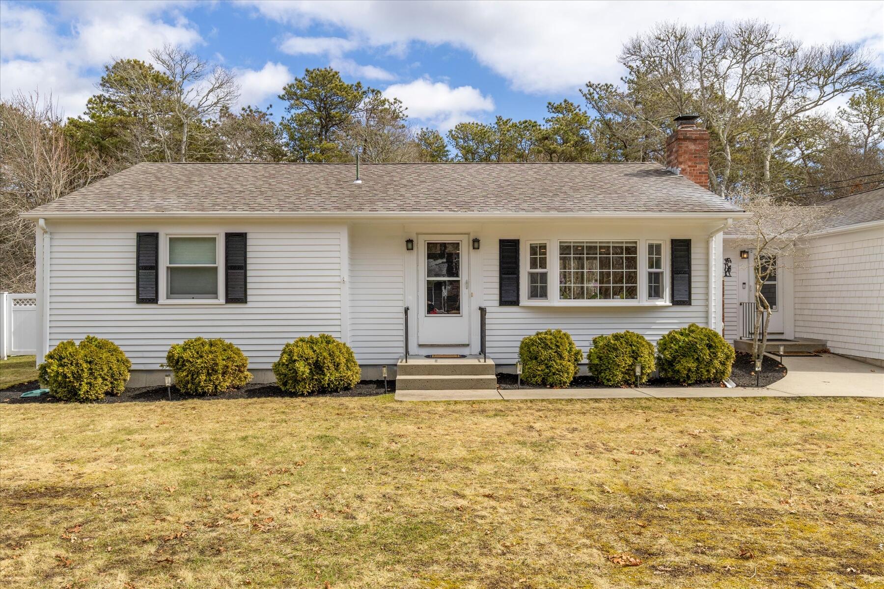 80 Coolidge Road West Yarmouth, MA 02673 - Photo 2 of 37 a front view of a house with yard and seating area