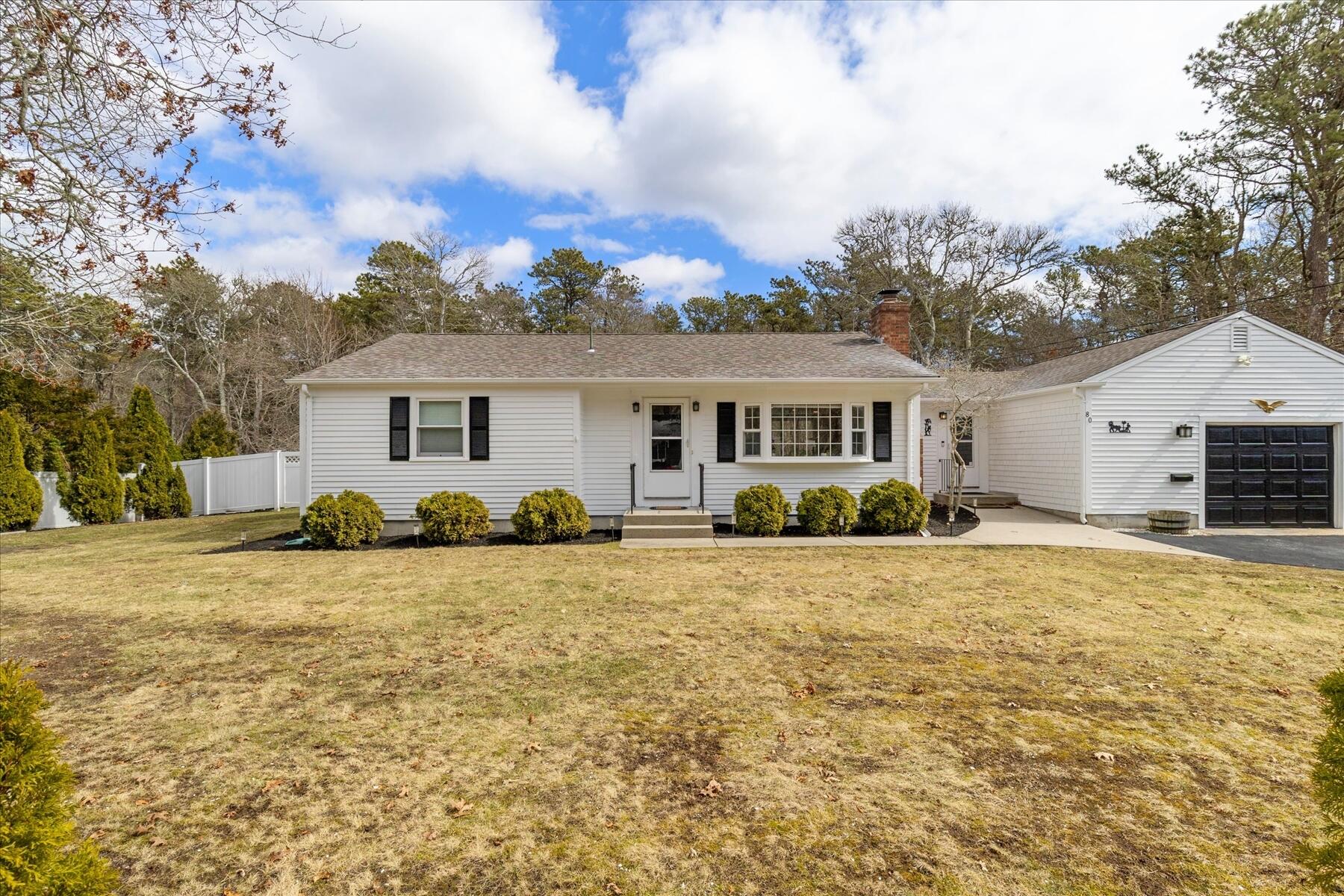 80 Coolidge Road West Yarmouth, MA 02673 - Photo 33 of 37 a front view of a house with a yard and garage