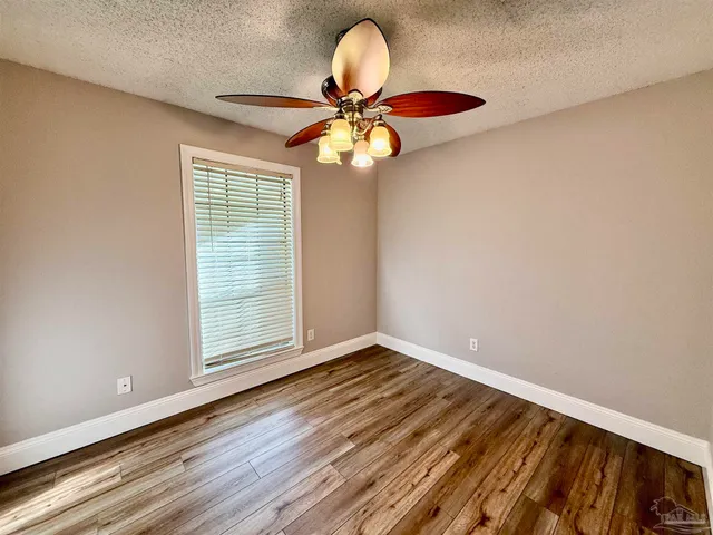 a view of room with window and ceiling fan