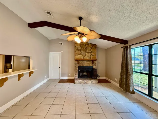 a view of a livingroom with a fireplace and a chandelier